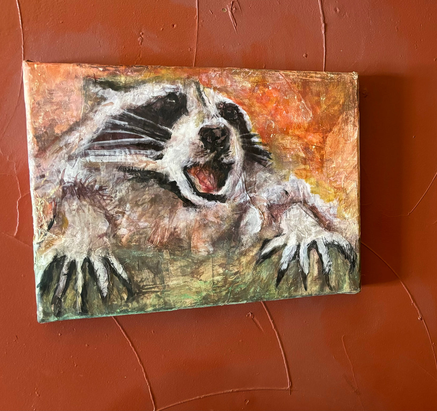 “Dumpster Fire Raccoon” mixed media on canvas by Noah